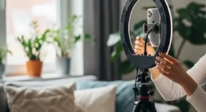 A content creator setting up a ring light for a mobile video shoot.