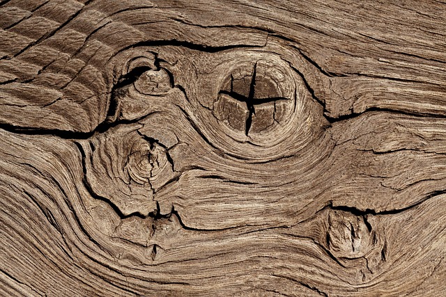 Close-up photo of a detailed wooden crucifix, showing grain and carved corpus
